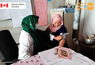 A midwife takes a woman's blood pressure at a family health house in rural Afghanistan. © UNFPA Afghanistan
