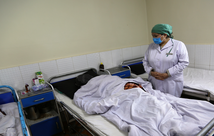 Dr. Nazifa Hamrah checks on Haadiya (face covered) after her fistula repair surgery at Malalai Maternity Hospital in Kabul.
