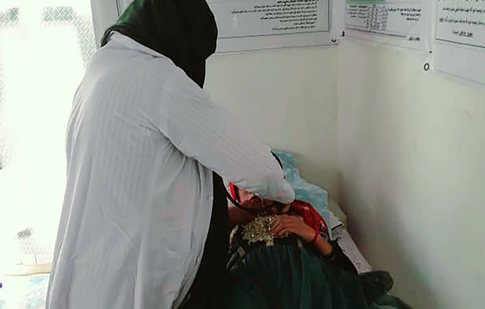 A midwife examining a pregnant woman