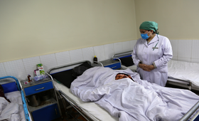 Dr. Nazifa Hamrah checks on Haadiya (face covered) after her fistula repair surgery at Malalai Maternity Hospital in Kabul.