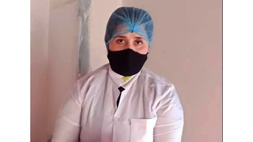 a midwife wearing a hair net and face mask