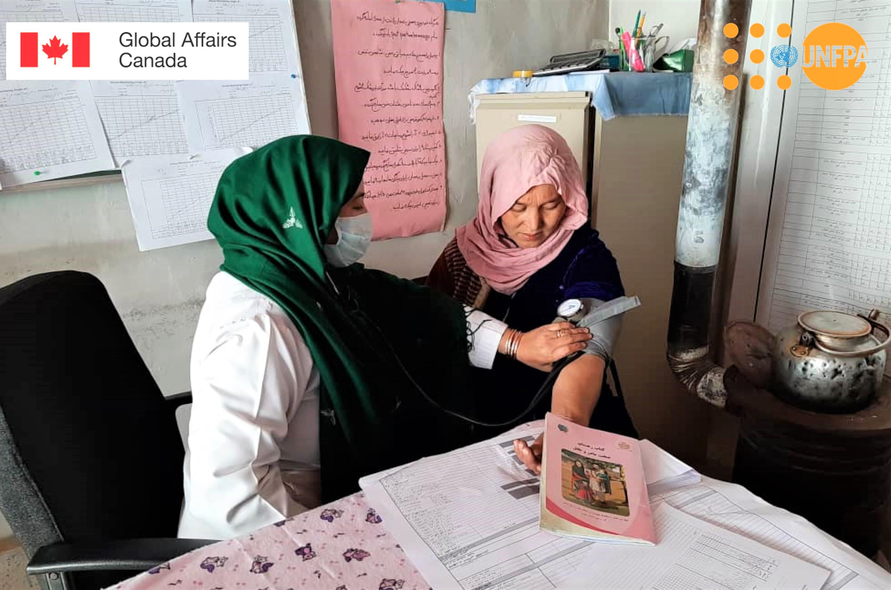 A midwife takes a woman's blood pressure at a family health house in rural Afghanistan. © UNFPA Afghanistan