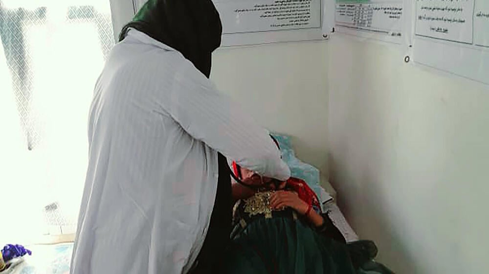 A midwife examining a pregnant woman