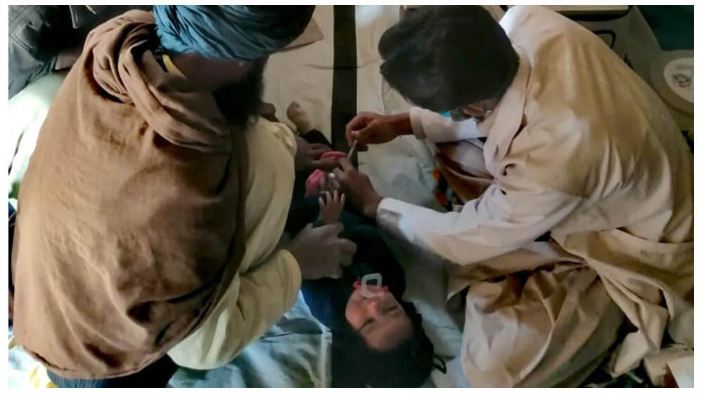 A health worker vaccinating a baby