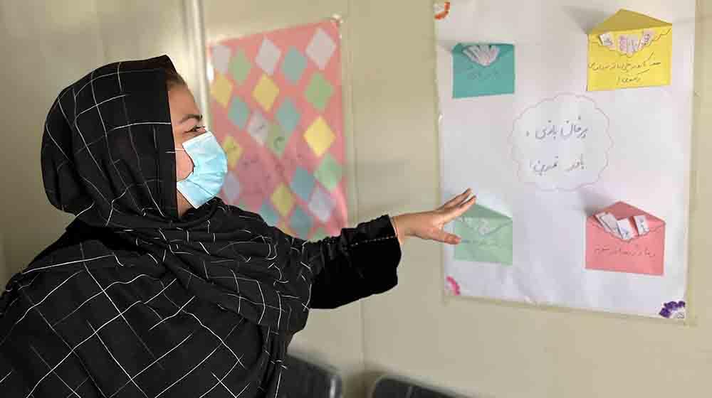 A psychosocial counselor reads notes on a board